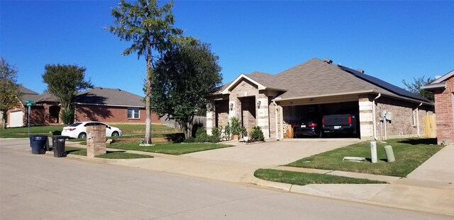 view of front of house with a garage and a front lawn