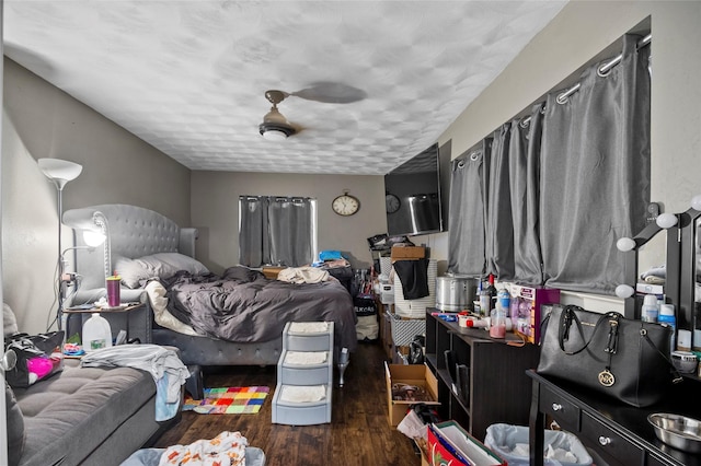 bedroom featuring dark hardwood / wood-style flooring and a textured ceiling