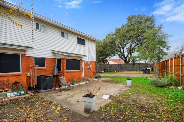 rear view of property featuring central AC unit and a patio area