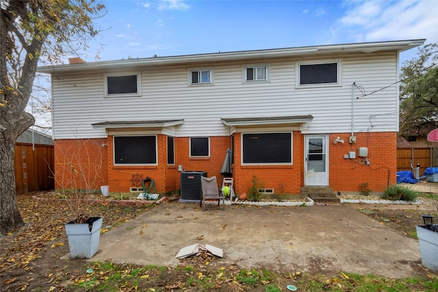 rear view of house with a patio area and central AC unit