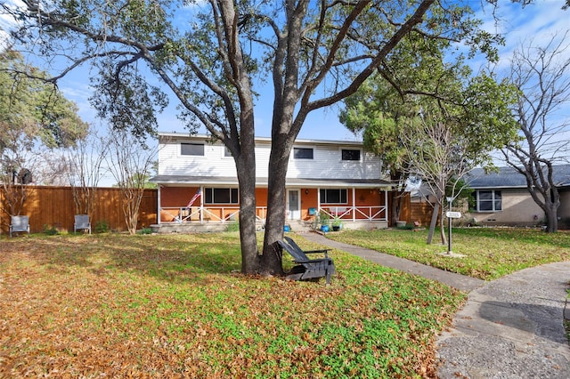 view of front facade with covered porch and a front yard