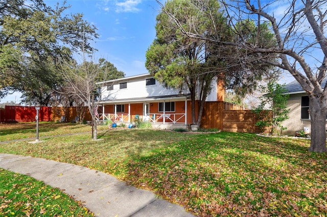 view of front of home with a porch and a front yard