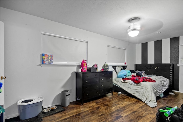 bedroom with ceiling fan and dark hardwood / wood-style floors