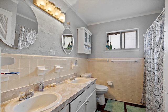 bathroom featuring crown molding, vanity, tile walls, and toilet