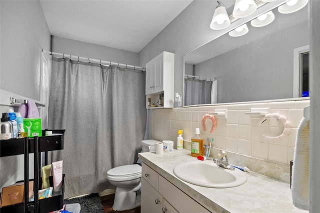 full bathroom featuring vanity, toilet, decorative backsplash, and shower / tub combo