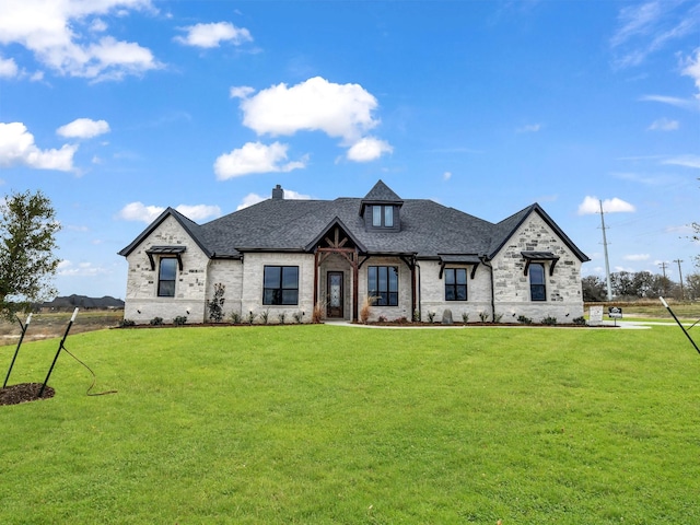 french country inspired facade with a front yard