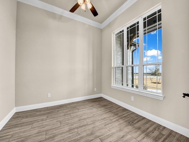 empty room featuring ceiling fan and ornamental molding