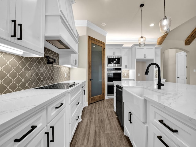 kitchen with backsplash, sink, white cabinets, and stainless steel appliances