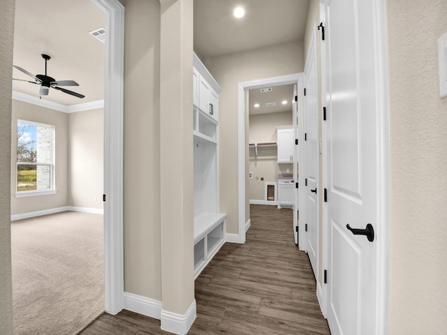 mudroom with dark carpet, ceiling fan, and ornamental molding