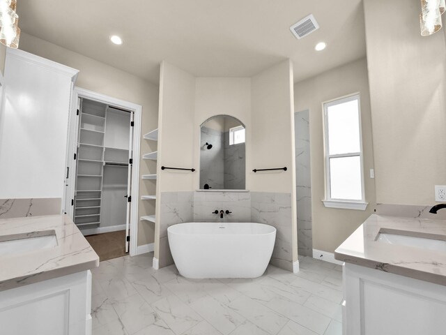 bathroom with vanity and separate shower and tub