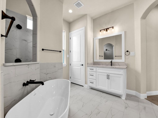 bathroom with vanity and a tub