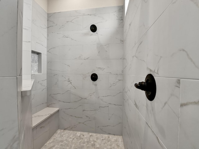 bathroom with a tile shower