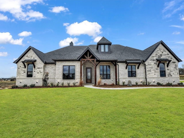 french country style house with a front yard