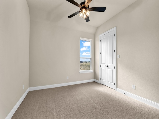 spare room with carpet flooring, ceiling fan, and lofted ceiling