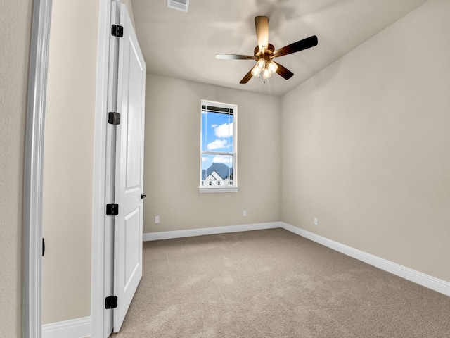 carpeted spare room featuring ceiling fan