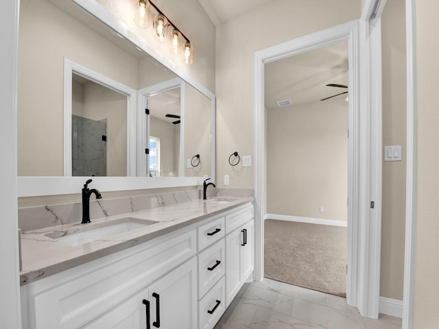 bathroom with ceiling fan and vanity