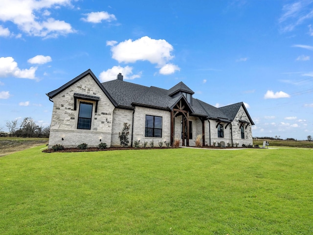 french country style house with a front lawn