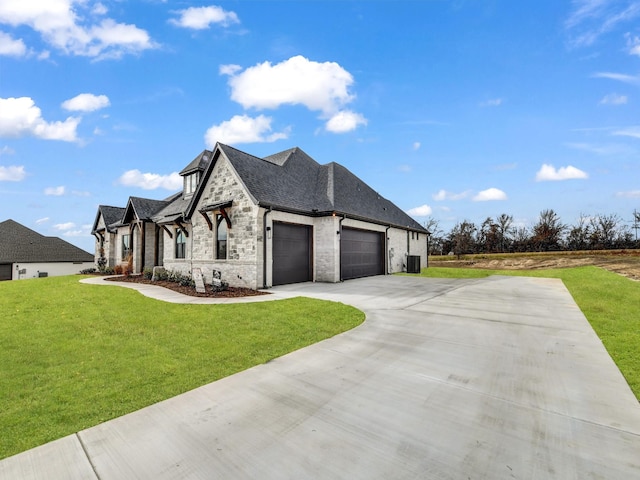 view of home's exterior featuring central AC, a yard, and a garage