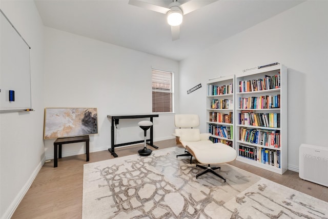 living area featuring ceiling fan and wood-type flooring