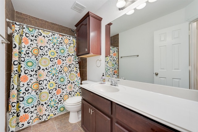 bathroom with tile patterned floors, vanity, and toilet