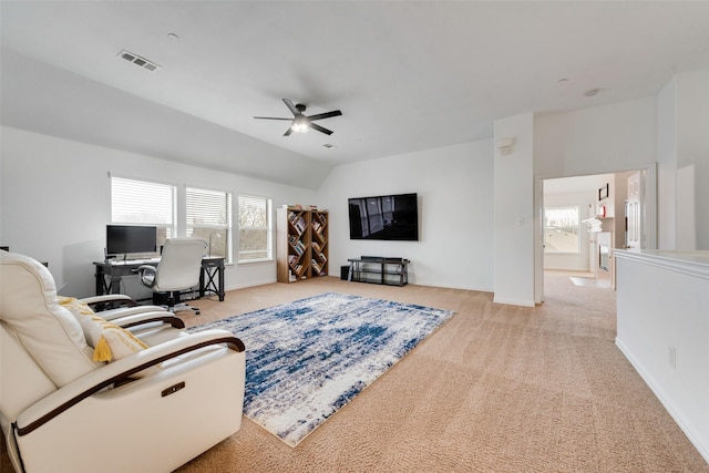 living room featuring ceiling fan, light colored carpet, and lofted ceiling