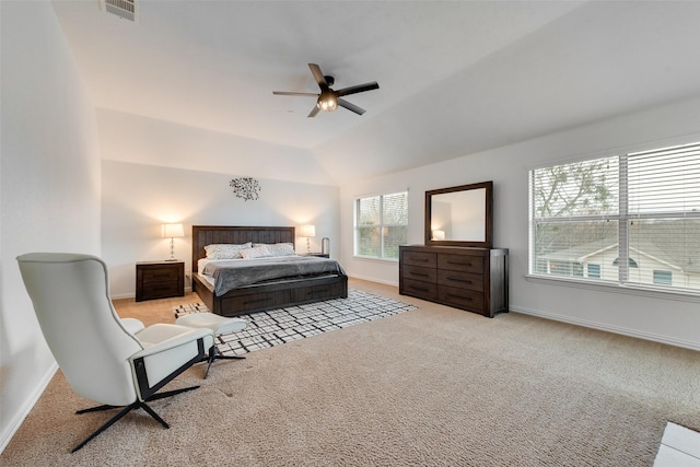 carpeted bedroom with ceiling fan and vaulted ceiling