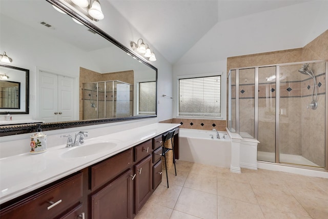 bathroom with tile patterned flooring, vanity, vaulted ceiling, and independent shower and bath