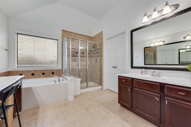 bathroom featuring plus walk in shower, vanity, lofted ceiling, and tile patterned flooring