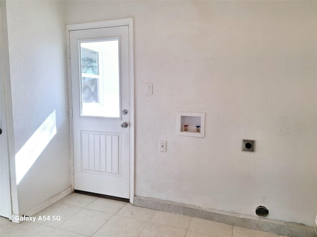 clothes washing area featuring electric dryer hookup, hookup for a washing machine, and light tile patterned floors