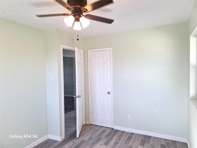 unfurnished bedroom featuring hardwood / wood-style floors and ceiling fan