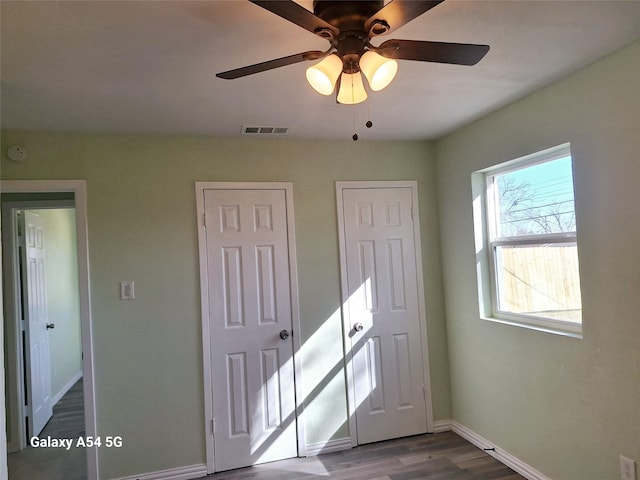 unfurnished bedroom featuring hardwood / wood-style flooring and ceiling fan