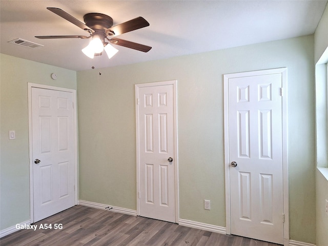 unfurnished bedroom with ceiling fan and wood-type flooring