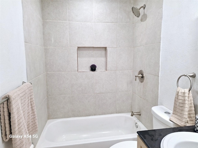 full bathroom featuring vanity, toilet, and tiled shower / bath combo