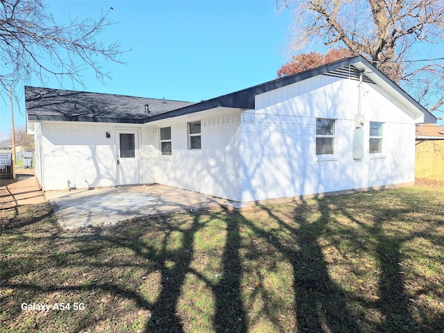 rear view of house featuring a lawn and a patio area