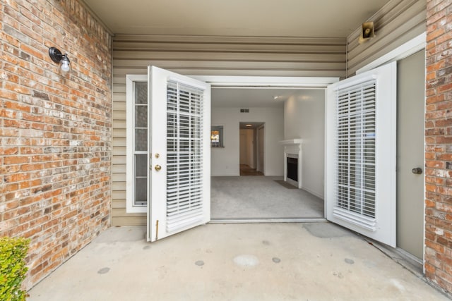 property entrance featuring a patio