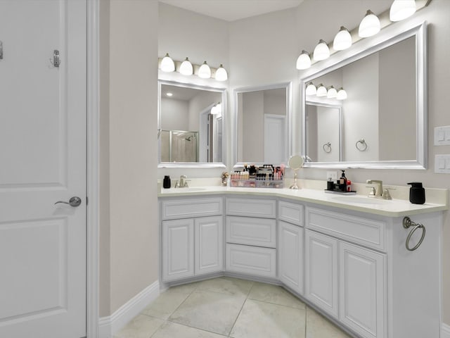 bathroom with tile patterned floors, vanity, and an enclosed shower