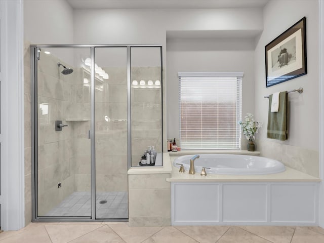 bathroom with a garden tub, a stall shower, and tile patterned floors