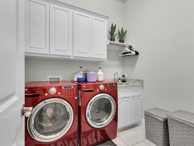 washroom featuring cabinets, sink, light tile patterned floors, and independent washer and dryer