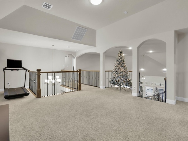 interior space with vaulted ceiling, baseboards, visible vents, and ceiling fan
