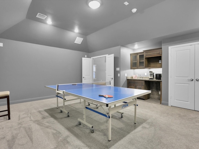 rec room featuring light colored carpet, sink, and vaulted ceiling