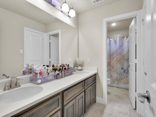 bathroom with tile patterned flooring, toilet, a shower with curtain, and a sink