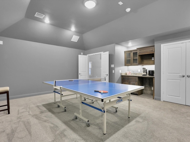 playroom with visible vents, light carpet, lofted ceiling, a sink, and baseboards