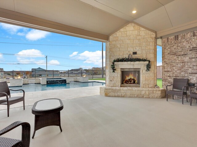 rear view of property featuring a swimming pool with hot tub, a yard, and a patio