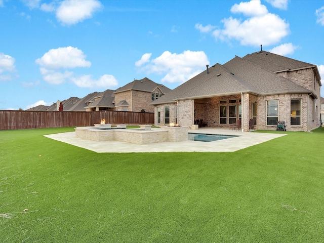 rear view of house with brick siding, a shingled roof, a yard, a fenced backyard, and a patio