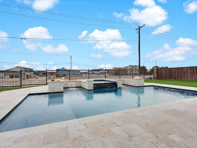 view of pool with an in ground hot tub, pool water feature, and a patio area