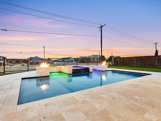 view of swimming pool featuring a patio, a fenced backyard, and an outdoor fire pit