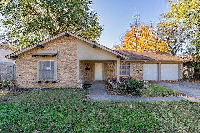 single story home featuring a garage and a front yard