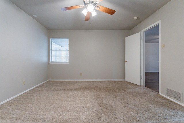 empty room featuring light colored carpet and ceiling fan