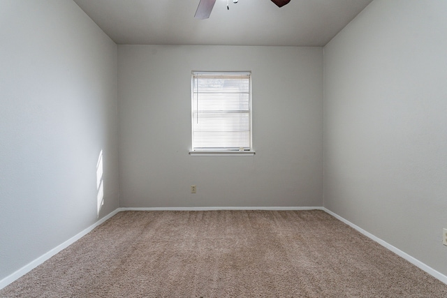 spare room featuring carpet and ceiling fan