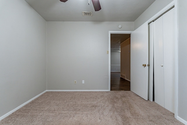 unfurnished bedroom featuring carpet and ceiling fan